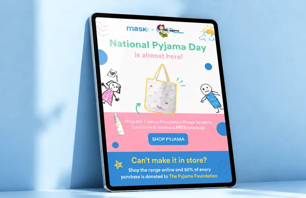 Tablet showing a MaskCo x Pyjama Foundation email for National Pyjama Day with a free tote bag, on blue