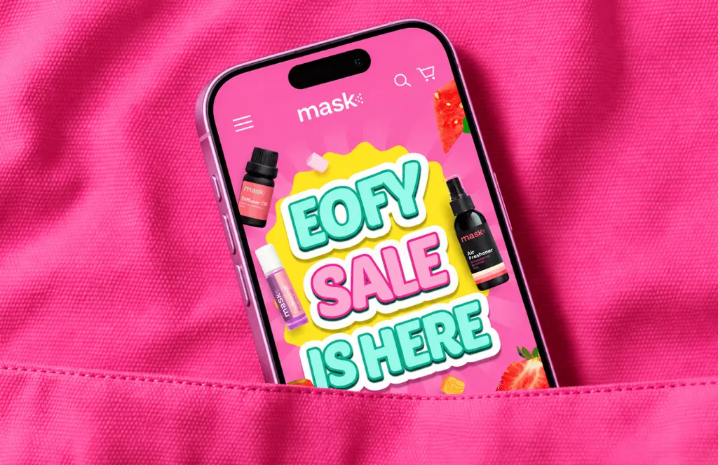 Phone in a pink pocket showing MaskCo’s EOFY Sale Is Here graphic with sprays and strawberries