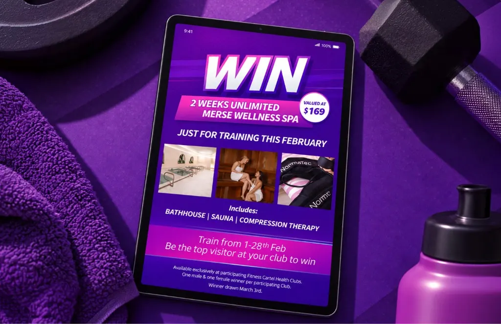 Tablet showing a Fitness Cartel contest to win two weeks at Merse Wellness Spa, beside a towel and dumbbell