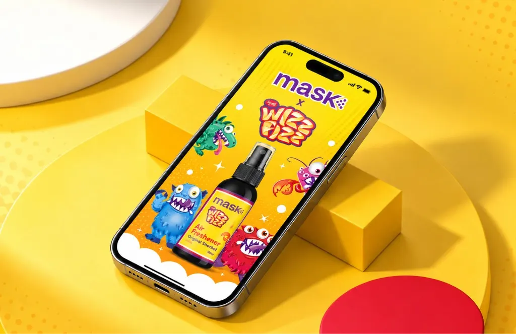 Phone on a yellow plinth showing a MaskCo Wizz Fizz air freshener ringed by cartoon monsters