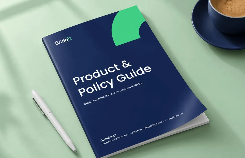 Navy Bridgit Product & Policy Guide on a mint table beside a pen and a cup of coffee