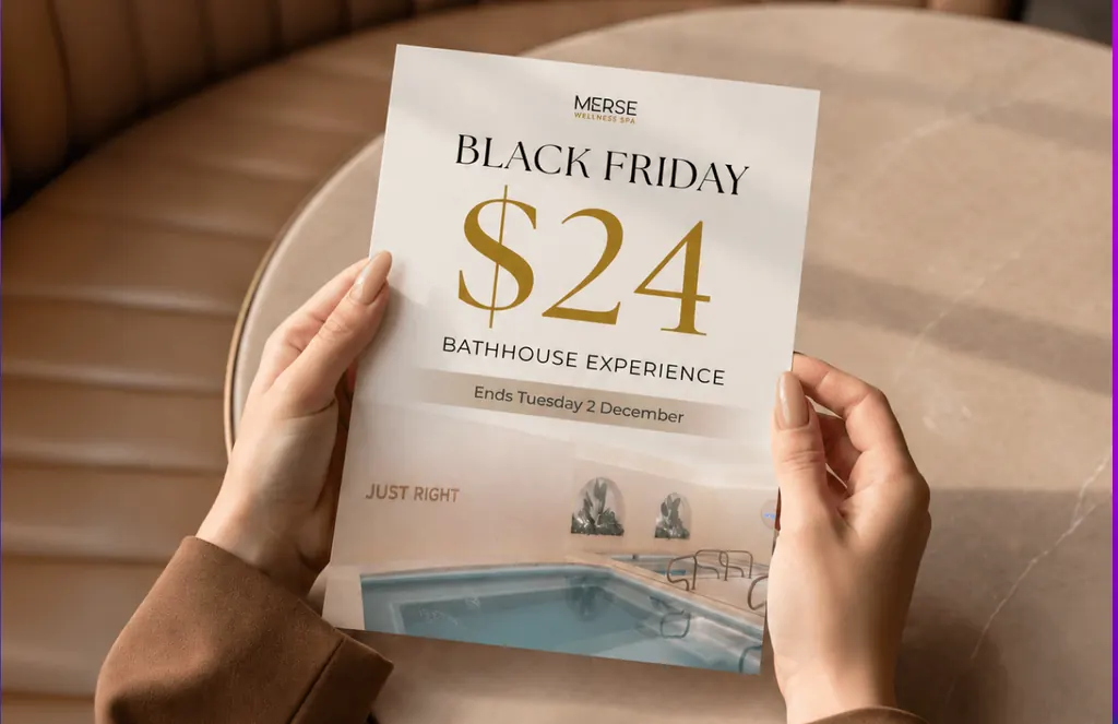 Hands holding a Merse Wellness Spa Black Friday flyer: a $24 bathhouse experience, ending Tuesday 2 December