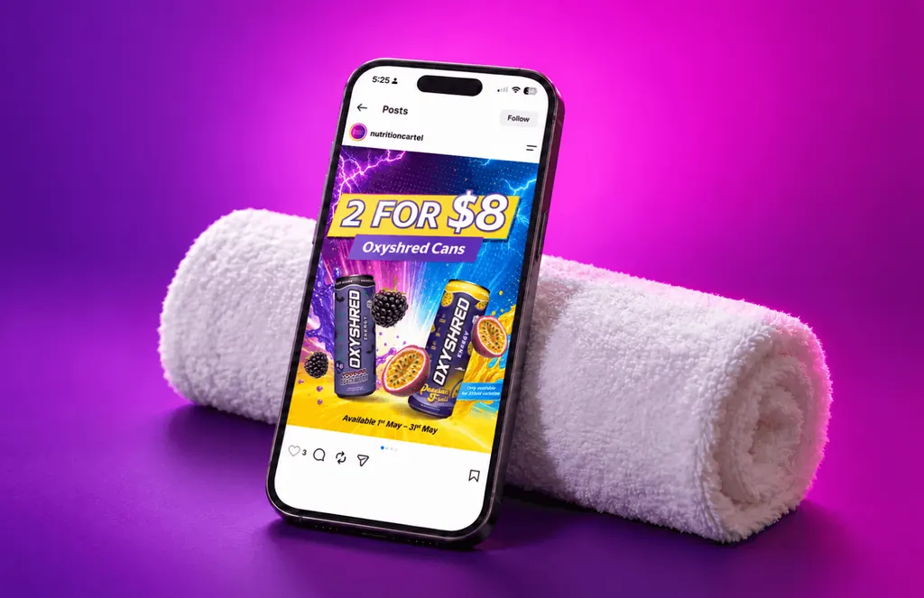 Phone on a rolled towel showing a Nutrition Cartel Instagram post: two Oxyshred cans for $8, on purple